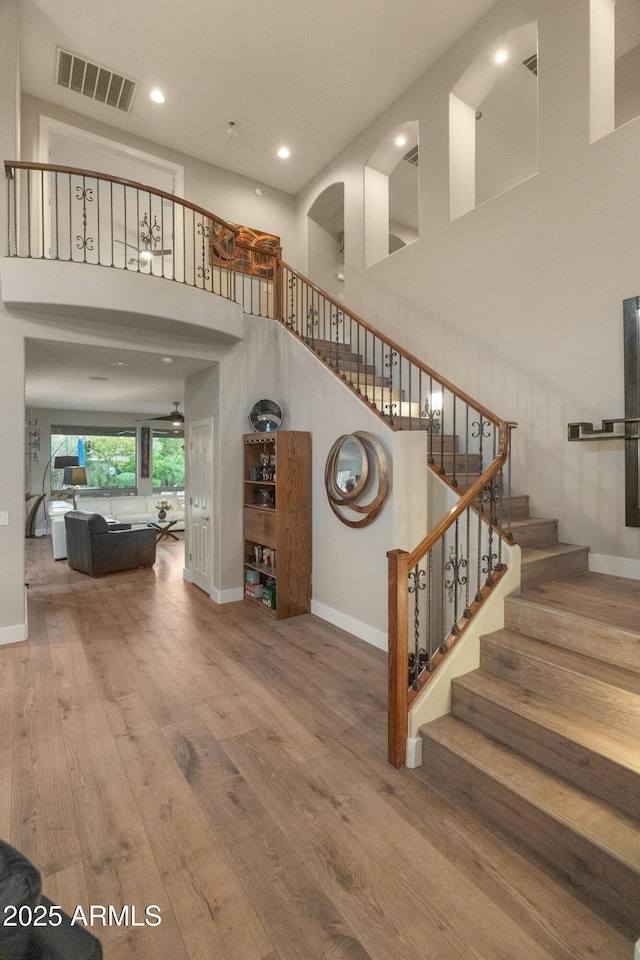 8447 W Tether Trl, Peoria, AZ 85383 - staircase with a towering ceiling, wood finished floors, and recessed lighting
