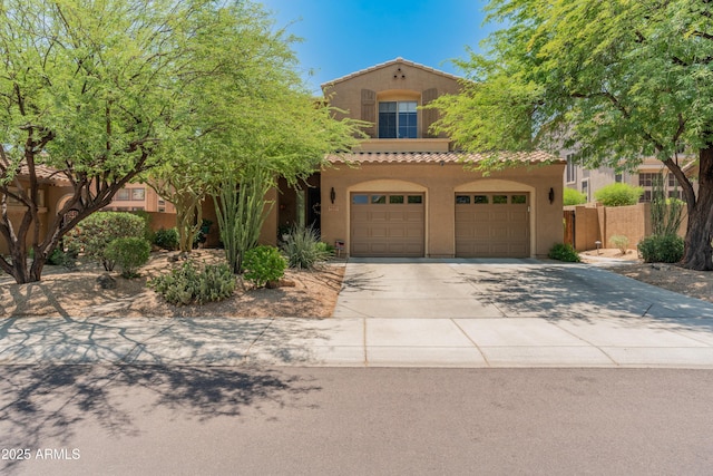 8447 W Tether Trl, Peoria, AZ 85383 - mediterranean / spanish home with stucco siding, driveway, a tiled roof, and an attached garage