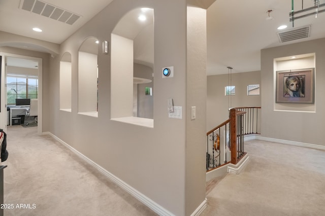 8447 W Tether Trl, Peoria, AZ 85383 - corridor with carpet, an upstairs landing, recessed lighting, and arched walkways
