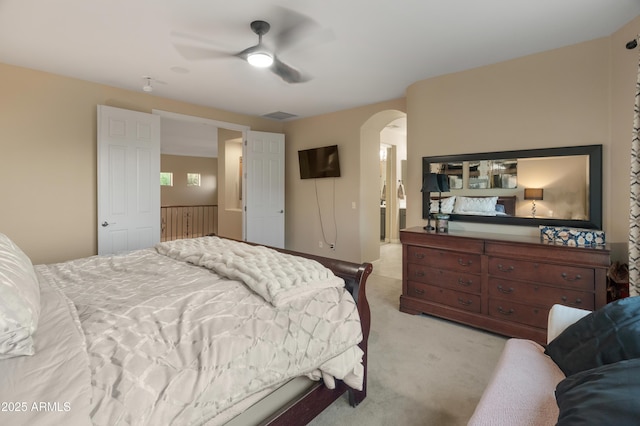 8447 W Tether Trl, Peoria, AZ 85383 - bedroom with arched walkways, light colored carpet, and a ceiling fan