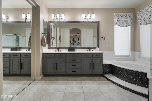 8447 W Tether Trl, Peoria, AZ 85383 - bathroom featuring double vanity, a bath, tile patterned floors, a stall shower, and ceiling fan