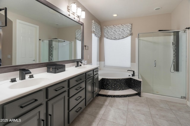 8447 W Tether Trl, Peoria, AZ 85383 - bathroom with a shower stall, a garden tub, double vanity, tile patterned floors, and recessed lighting
