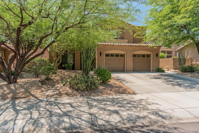 8447 W Tether Trl, Peoria, AZ 85383 - view of front of home featuring concrete driveway, stucco siding, a tiled roof, and an attached garage
