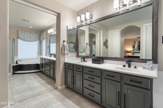 8447 W Tether Trl, Peoria, AZ 85383 - full bath with double vanity, a garden tub, tile patterned floors, and ensuite bathroom