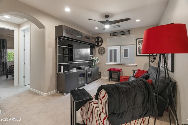 8447 W Tether Trl, Peoria, AZ 85383 - living area featuring arched walkways, ceiling fan, recessed lighting, and light carpet