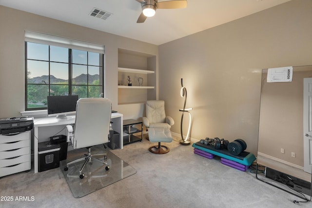 8447 W Tether Trl, Peoria, AZ 85383 - carpeted home office with a ceiling fan and built in shelves