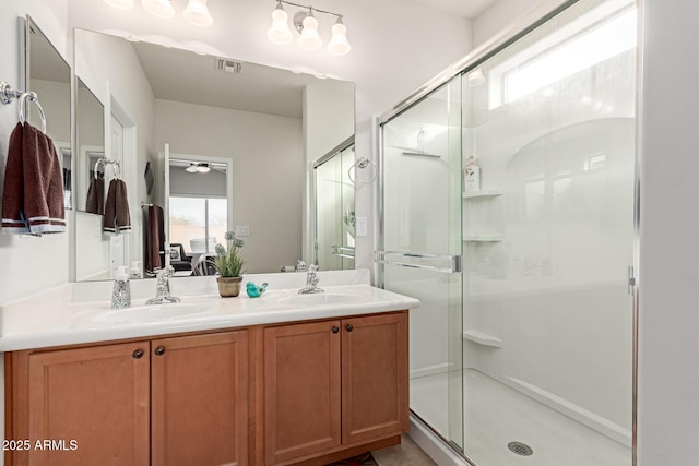 bathroom featuring a shower with door, vanity, and ceiling fan