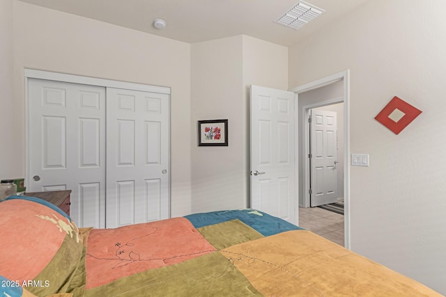 bedroom featuring light tile patterned floors and a closet