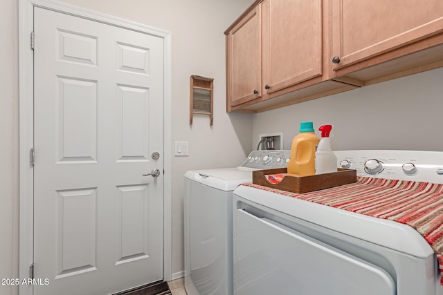 washroom featuring cabinets and separate washer and dryer