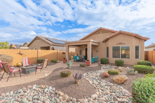 back of house with a patio and a fire pit