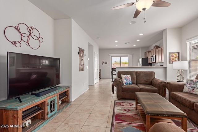 living room with light tile patterned floors and ceiling fan