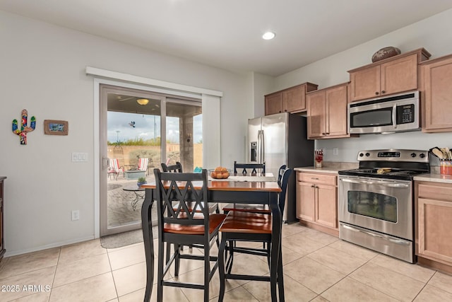 kitchen featuring stainless steel appliances and light tile patterned flooring