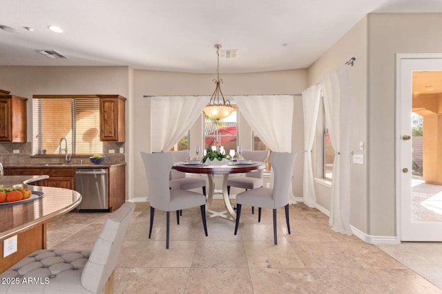 dining room featuring a healthy amount of sunlight and sink