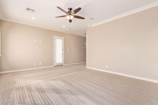 carpeted empty room with ceiling fan and crown molding