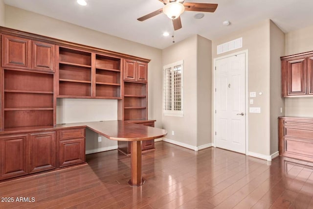 unfurnished office featuring ceiling fan and dark wood-type flooring