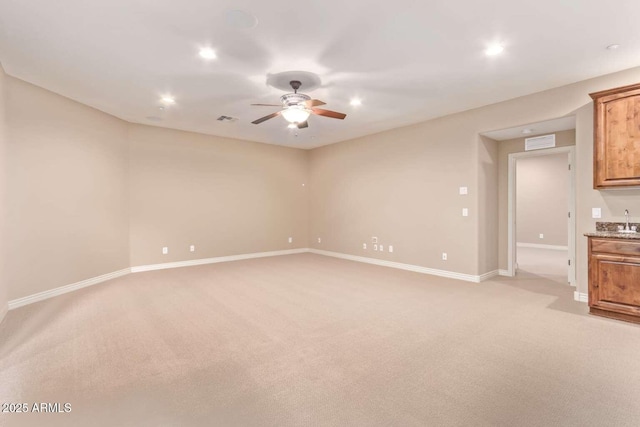 unfurnished living room with light carpet and ceiling fan