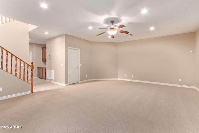 interior space featuring ceiling fan and light colored carpet