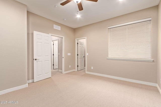 unfurnished room featuring ceiling fan and light colored carpet