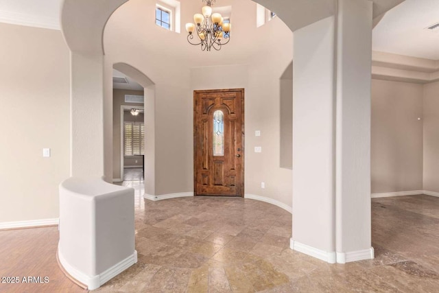 foyer entrance featuring a chandelier and ornamental molding