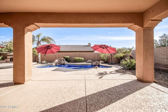 view of patio / terrace with a fenced in pool