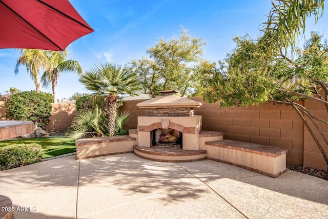 view of patio / terrace with an outdoor stone fireplace