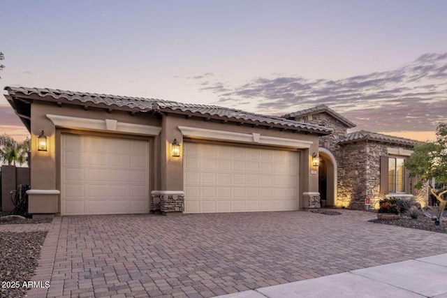 mediterranean / spanish-style home with a garage