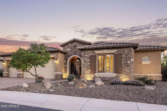 mediterranean / spanish-style house with a garage