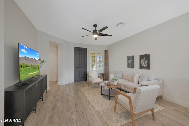 living room with light hardwood / wood-style flooring and ceiling fan