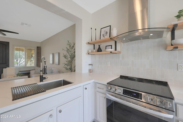 kitchen featuring stainless steel range with electric stovetop, white cabinets, sink, decorative backsplash, and island exhaust hood