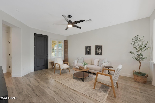 living room featuring ceiling fan and light hardwood / wood-style flooring