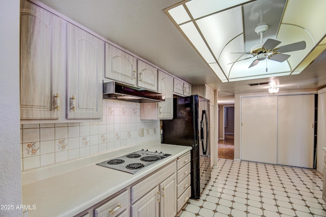 kitchen featuring ceiling fan, backsplash, black refrigerator with ice dispenser, and electric stovetop