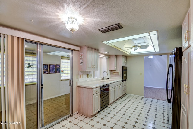 kitchen featuring black appliances, sink, and a textured ceiling