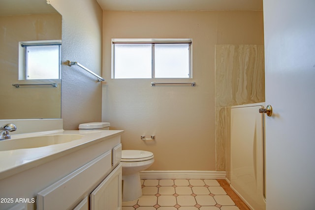 bathroom featuring vanity, toilet, and a shower