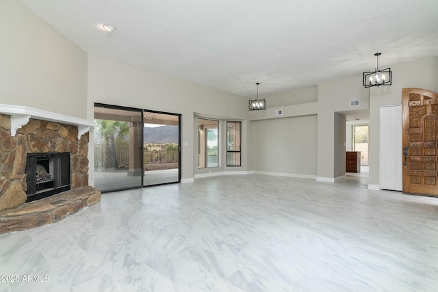 unfurnished living room featuring plenty of natural light, visible vents, a notable chandelier, and a stone fireplace