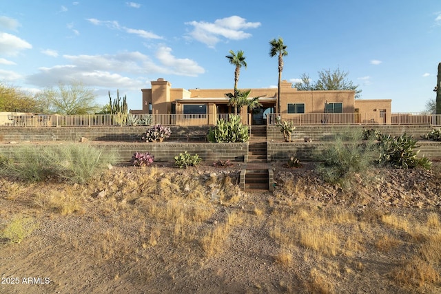 exterior space featuring stairway and fence