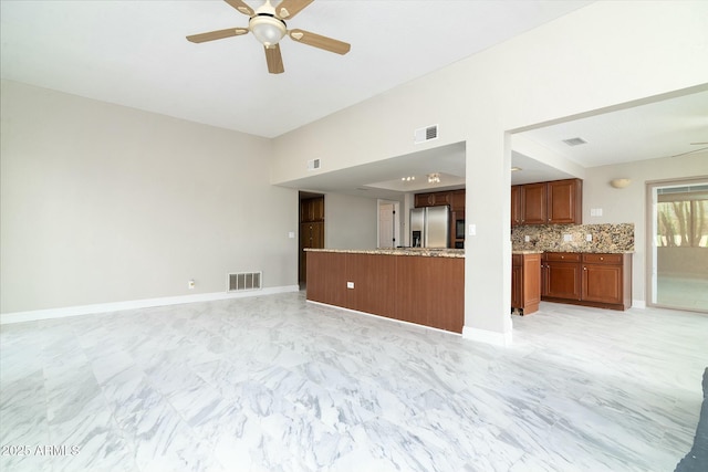 unfurnished living room featuring a ceiling fan, marble finish floor, visible vents, and baseboards