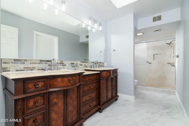 full bath featuring toilet, visible vents, marble finish floor, backsplash, and double vanity