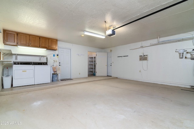 garage featuring washing machine and dryer and a garage door opener