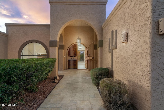 property entrance with stucco siding