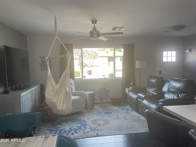 living room with wood-type flooring and ceiling fan