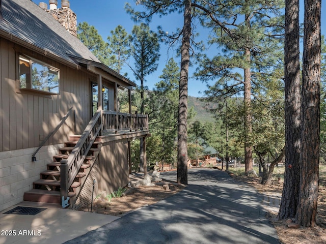 5130 Juniper Loop, Pine, AZ 85544 - view of side of property with a shingled roof and a chimney