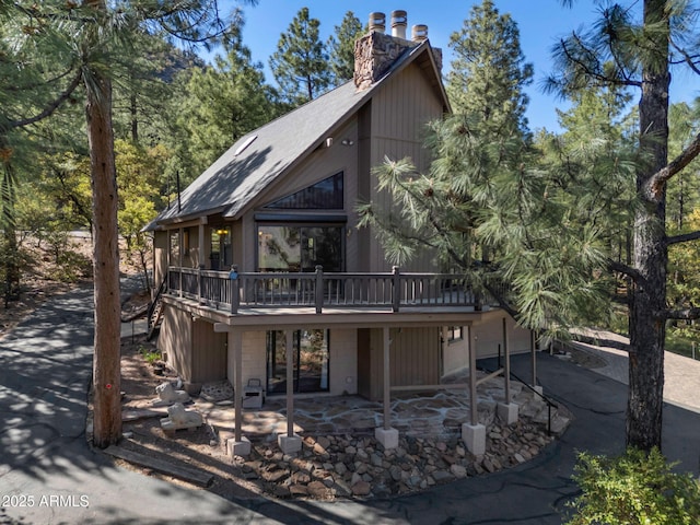 5130 Juniper Loop, Pine, AZ 85544 - rear view of house featuring a wooden deck, a chimney, and a patio area