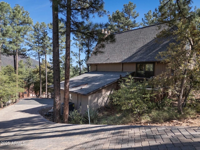 5130 Juniper Loop, Pine, AZ 85544 - view of side of property with a shingled roof, central air condition unit, and driveway