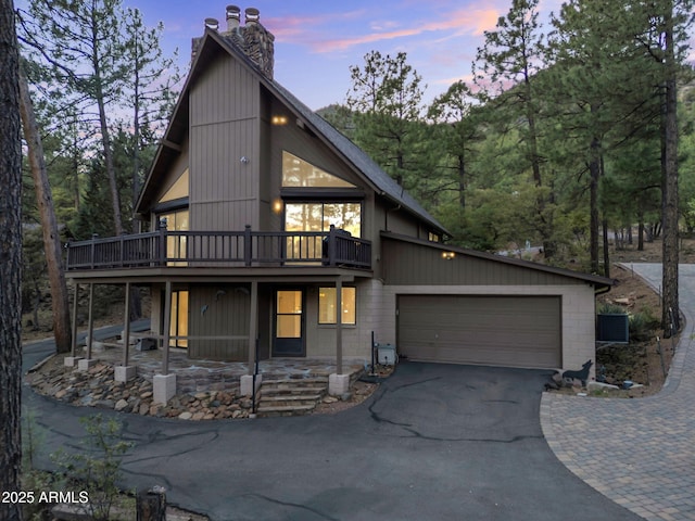 5130 Juniper Loop, Pine, AZ 85544 - view of front of property with driveway, a chimney, an attached garage, and a deck