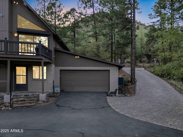 5130 Juniper Loop, Pine, AZ 85544 - view of side of home featuring asphalt driveway, an attached garage, a balcony, and concrete block siding