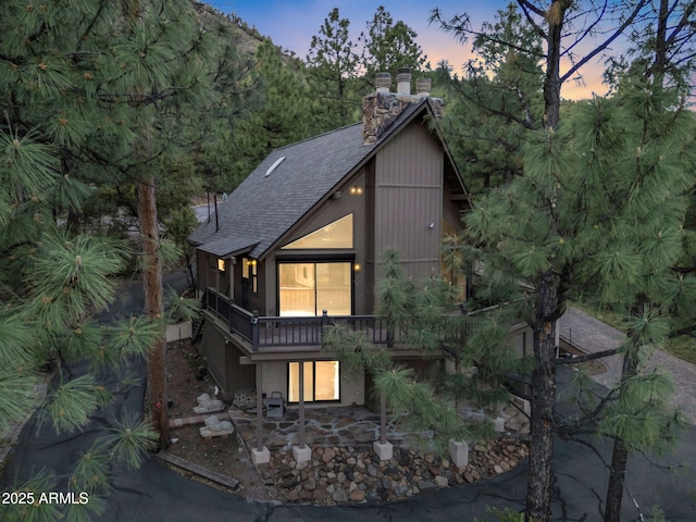 5130 Juniper Loop, Pine, AZ 85544 - view of front facade with roof with shingles, a chimney, and a patio