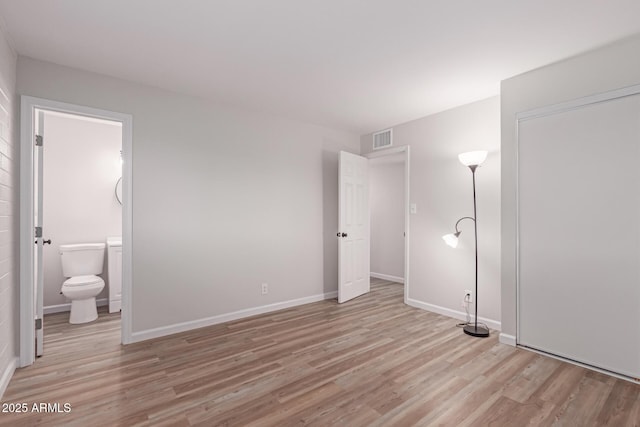 3812 W Seldon Ln, Phoenix, AZ 85051 - unfurnished bedroom with light wood-style flooring and connected bathroom