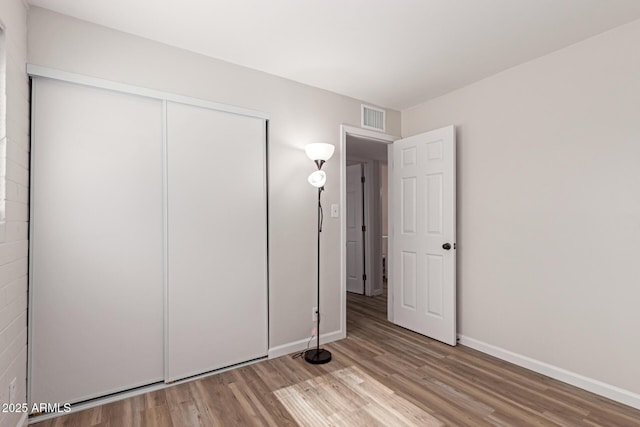 3812 W Seldon Ln, Phoenix, AZ 85051 - unfurnished bedroom featuring wood finished floors and a closet