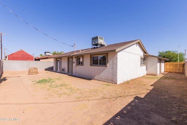 3812 W Seldon Ln, Phoenix, AZ 85051 - rear view of house with a fenced backyard, stucco siding, and roof with shingles