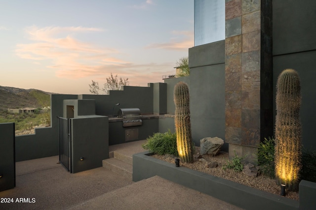 exterior space with a mountain view and an outdoor kitchen